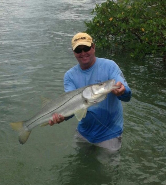 Capt. Todd returns to the boat after retrieving a 15 lb. snook from deep in the mangrove cover.  